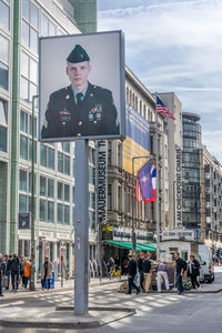 People on street in city against sky