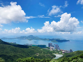 Panoramic shot of city by sea against sky