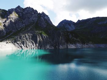 Scenic view of lake and mountains against sky