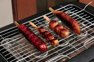 High angle view of meat on barbecue grill