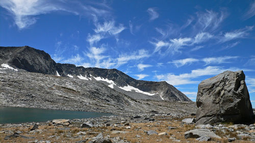 Scenic view of mountains against blue sky