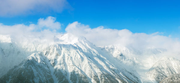 Panoramic view of snowcapped mountains against sky