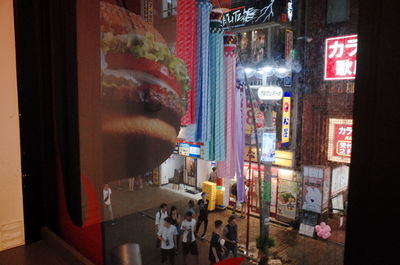 People on illuminated street at night