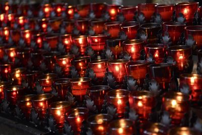 Lit tea light candles in temple