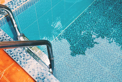 High angle view of ladder at poolside