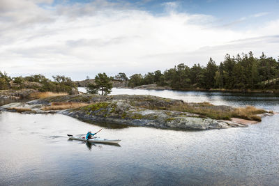 Person kayaking on sea