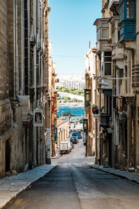 Street amidst buildings in town against clear sky