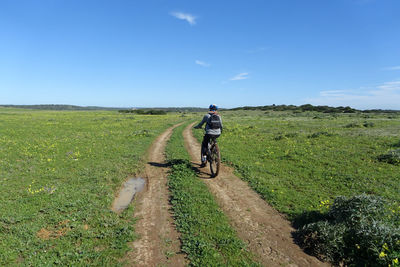 Man riding bicycle on field