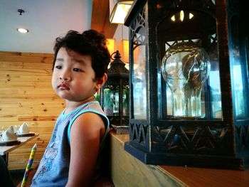 Portrait of boy sitting at home