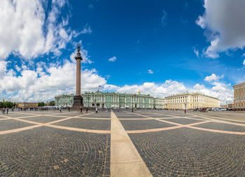 View of monument in city against cloudy sky