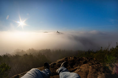 People on mountain against sky