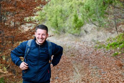 Portrait of a smiling man standing in forest