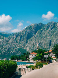 Scenic view of buildings and mountains against sky