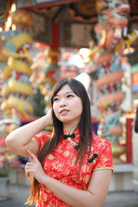 Portrait of beautiful young woman standing outdoors