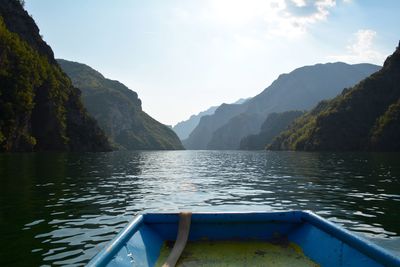 Scenic view of lake by mountains against sky