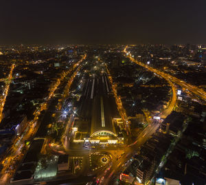 High angle view of city lit up at night
