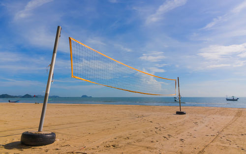 Beach volleybal net on beach against sky