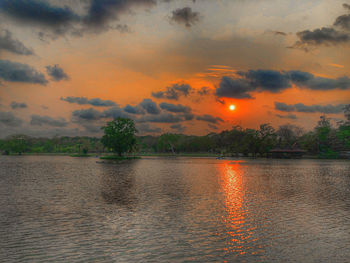 Scenic view of lake against orange sky