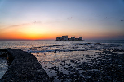 Scenic view of sea against sky during sunrise