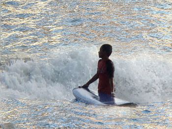 Rear view of boy on sea shore