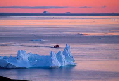 High angle view of icebergs in sea during sunset