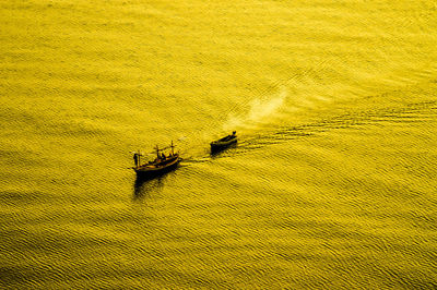 High angle view of yellow boat on beach