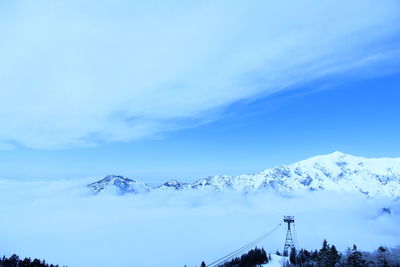 Scenic view of snowcapped mountains against blue sky