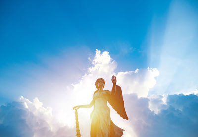 Low angle view of statue against sky