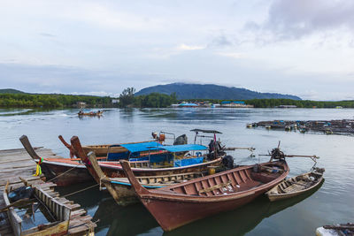Long-tail fishing boat moored at ban sam chong nuea pier, phang nga estuary, phang nga, thailand.