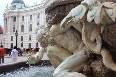 Statue of fountain in front of building