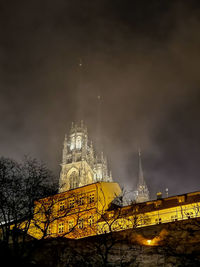 Low angle view of illuminated buildings against sky at night