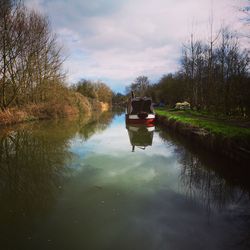 Boat in canal against sky