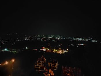 High angle view of illuminated city against sky at night