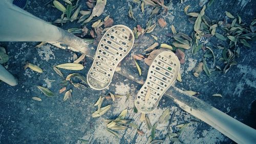 High angle view of messy shoes on field