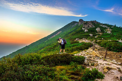 Man photographing through camera while standing on mountains at seoraksan national park
