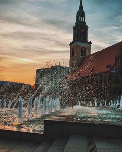 Fountain against sky during sunset