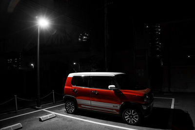 Car on illuminated street at night