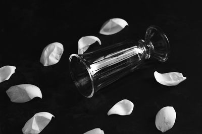 High angle view of glasses on table against black background