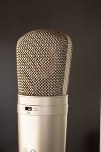 Close-up of microphone against gray background