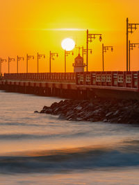 Beautiful sea and the bridge stretches out into the middle of the water with rows of lampposts