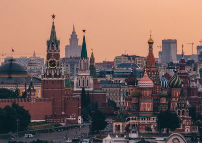 Buildings in city at sunset