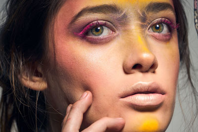 Close-up portrait of young woman with face paint