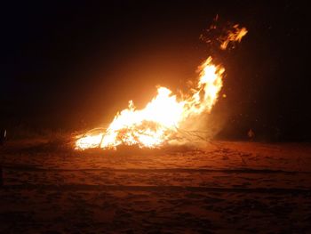Close-up of bonfire against clear sky at night