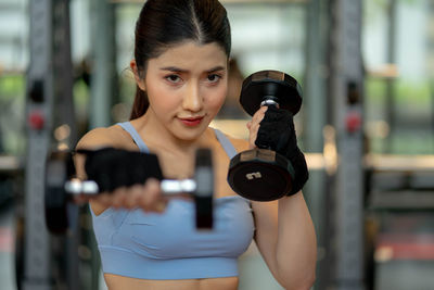 Young woman exercising in gym