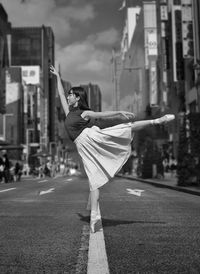 Side view of woman walking on road in city