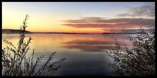 Scenic view of lake at sunset