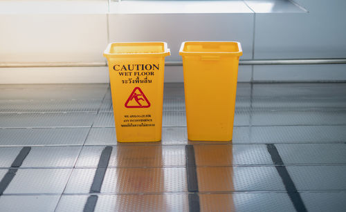 Close-up of yellow text on tiled floor