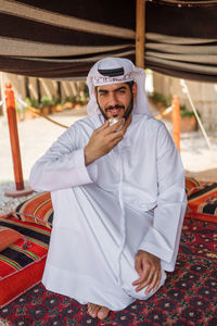 Portrait of young man sitting at home