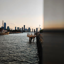 Boats in sea against sky during sunset