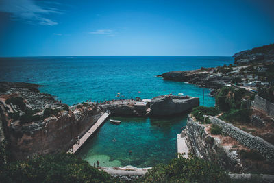 High angle view of sea against clear blue sky